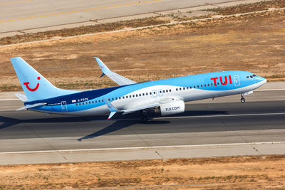 Side view of airplane on airport runway