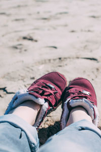 Low section of man relaxing on beach