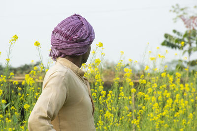 Indian farmer looking at his crop in agricultural farm