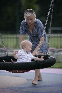 Full length of girl on swing