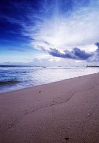 Scenic view of sea against cloudy sky