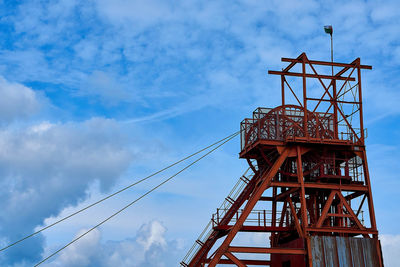 Low angle view of crane against sky