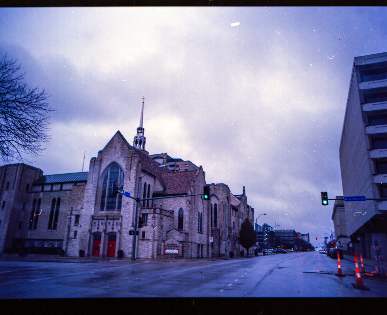 STREET AMIDST BUILDINGS AGAINST SKY