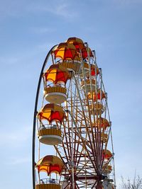 Low angle view of ferris wheel against sky