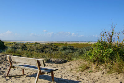 Scenic view of beach against blue sky