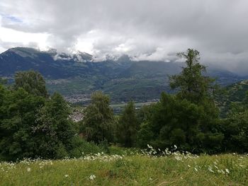 Scenic view of mountains against cloudy sky