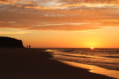 Scenic view of sea against orange sky