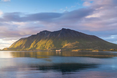 Scenic view of lake by mountains against sky