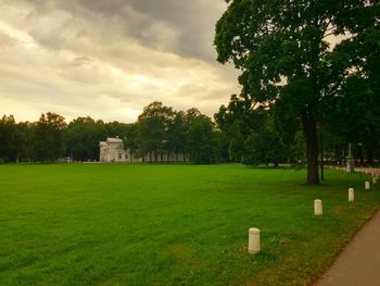 Scenic view of grassy field against cloudy sky