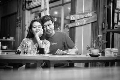 Young couple sitting on table at restaurant
