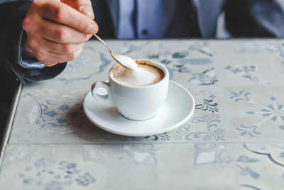 Mid adult businessman drinking coffee on a break in a cafe.