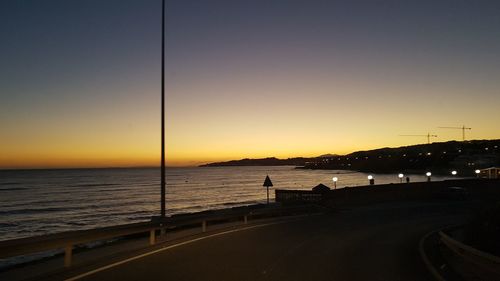 Scenic view of sea against clear sky at sunset