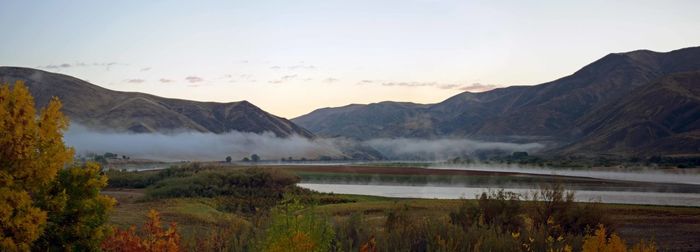 Scenic view of lake and mountains against sky