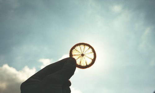 Low angle view of woman hand against sky