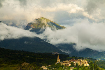 Scenic view of mountains against cloudy sky