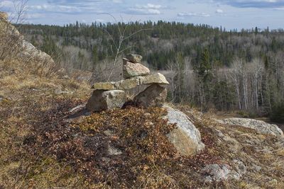 Rocks on field against sky
