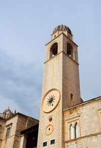 Low angle view of bell tower against sky