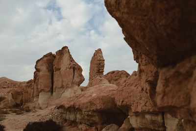 Low angle view of rock formation against sky