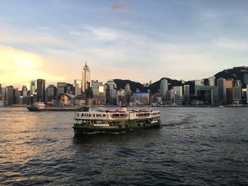 Boats in river with buildings in background