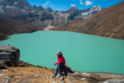 Man standing on rock against mountains