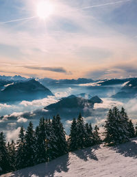 Scenic view of snowcapped mountains against sky during sunset