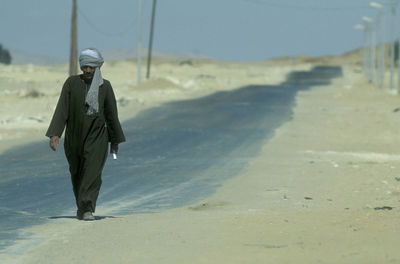 Rear view of man standing at beach