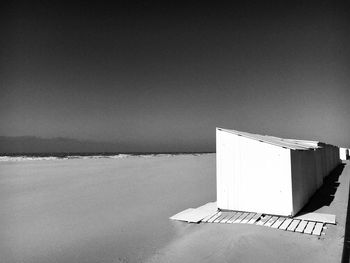 Built structure on beach against clear sky