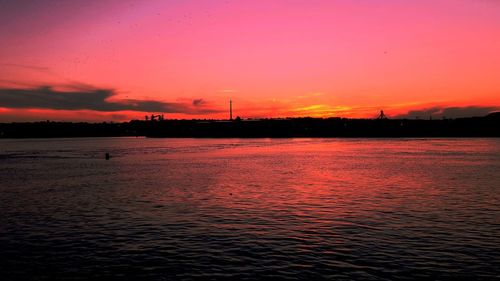 Scenic view of sea against orange sky