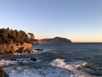 Scenic view of sea against clear sky during sunset