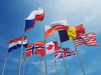 Low angle view of flags against sky