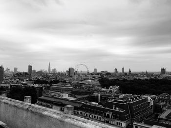 View of cityscape against cloudy sky