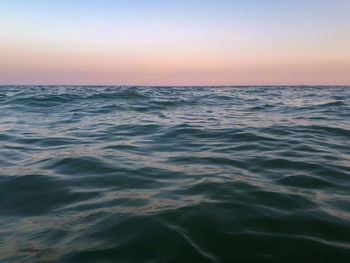 Scenic view of sea against clear sky during sunset