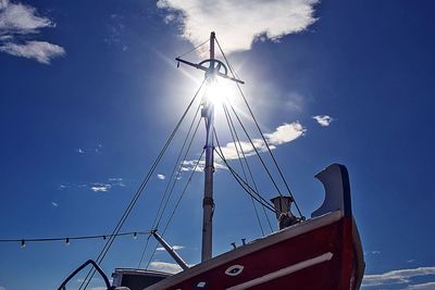 Low angle view of crane against sky