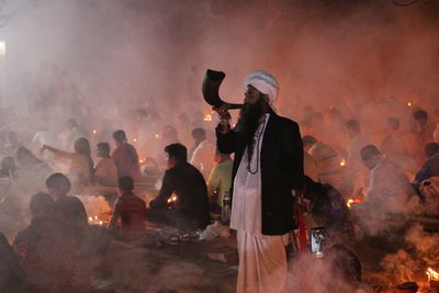 A saint blowing buffalo horn in rakher upobash at barodi lokhnath brahmachari ashram