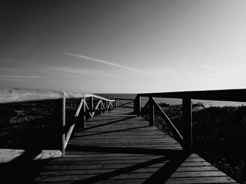 Footbridge over pier against sky