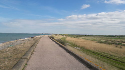 Road by sea against sky