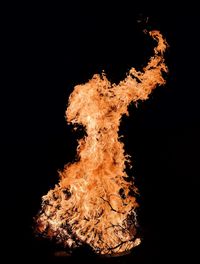 Close-up of bonfire against black background