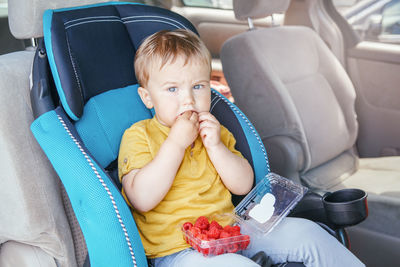 Portrait of boy sitting in car