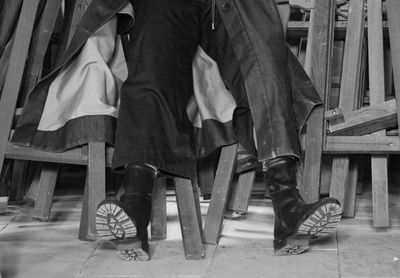 Low section of people sitting on chair