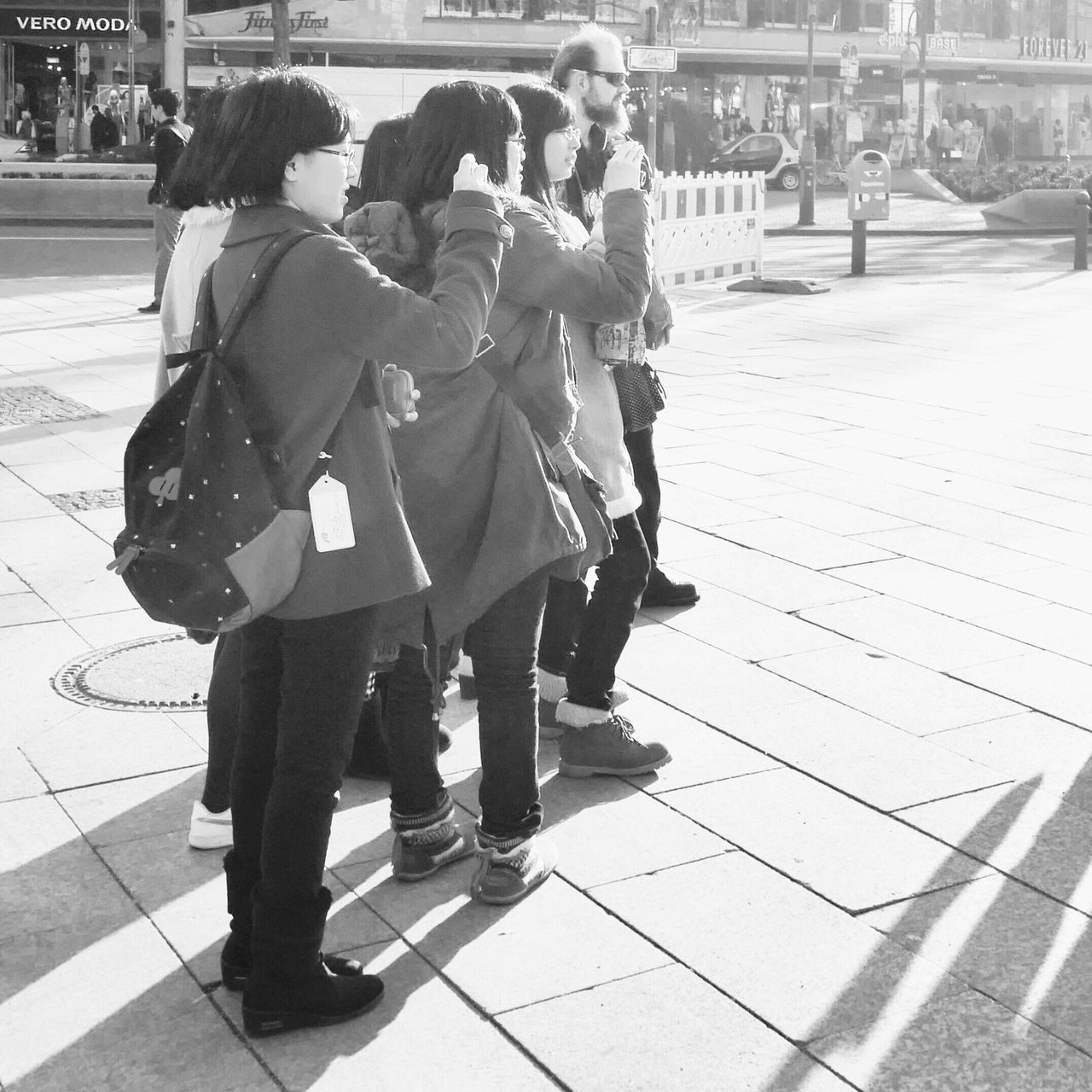 shadow, sunlight, sidewalk, full length, street, lifestyles, walking, tiled floor, person, footpath, high angle view, standing, leisure activity, outdoors, rear view, day, paving stone, casual clothing