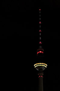 Communications tower against sky at night