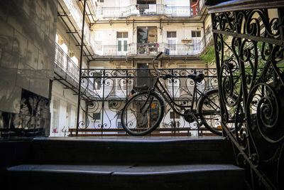 Bicycle parked by railing in city