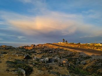 Scenic view of land against sky during sunset