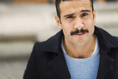 Portrait of young man at tram station