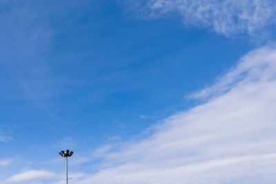 Low angle view of street light against blue sky