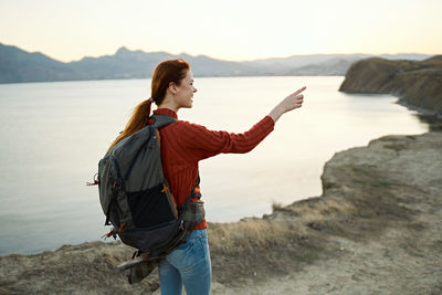 Man standing on beach against mountain