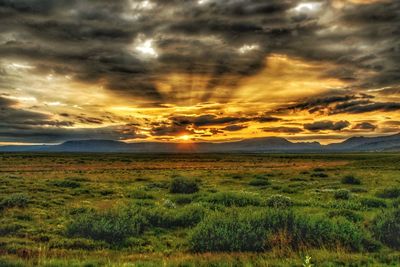 Scenic view of landscape against dramatic sky