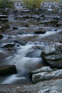 View of stream flowing through rocks