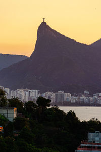 Scenic view of buildings in city against sky during sunset