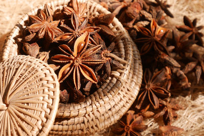 High angle view of star anise in wicker basket